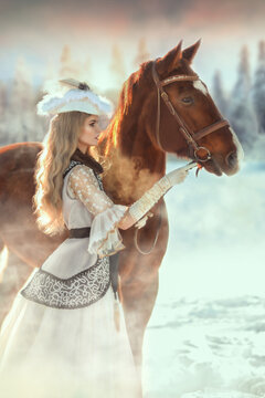 A blonde girl with a horse in the winter forest in a historical costume. Art photo