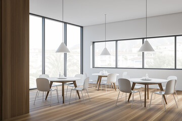 Modern cafe interior with white tables and chairs, panoramic windows