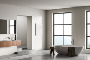 Fototapeta na wymiar Light bathroom interior with sink and bathtub, panoramic window