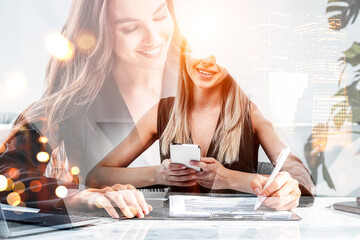 Business colleagues with smartphone and pen in hand writing, business skyscrapers