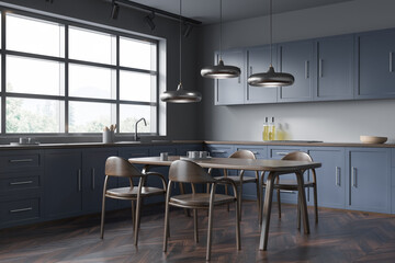 Grey and blue kitchen and dining room combo. Corner view.