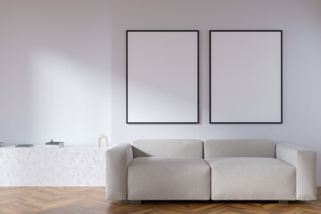 Bright living room interior with two empty white posters, sofa