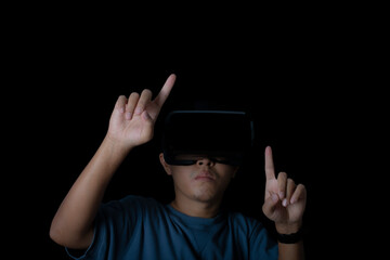 Studio portrait man wearing VR Headset touching something by his fingers on black background.