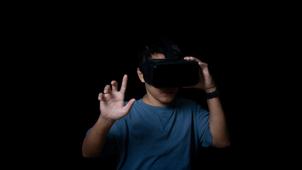 Studio portrait man wearing VR Headset touching something by his fingers on black background. Glasses of virtual reality.