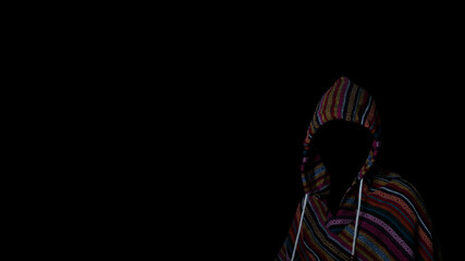 Scary and creepy man hiding in the shadows, with the face and identity hidden with the hood, Dark mysterious man in hoodie on black background. Concept for fear, mystery, danger, hacker.