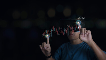 Man wearing VR Headset showing growing virtual hologram stock market, trading statistic business and increase in the indicators of positive growth, stock investment financial metaverse concept.