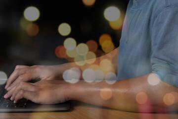 man hands typing on laptop keyboard and surfing the internet on office table, online, working, business and technology, work from home, internet network communication on bokeh light background.