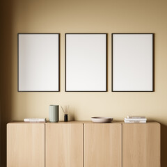 Three empty canvases with living room sideboard on yellow background