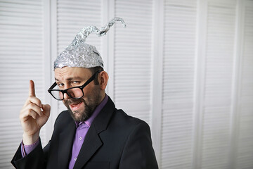 Bearded funny man in a cap of aluminum foil. Concept art phobias.Conspiracy theory. Conspiracy....