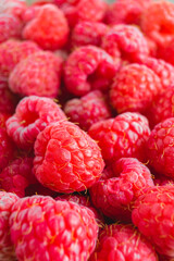 Fresh and sweet red organic raspberries close up texture background