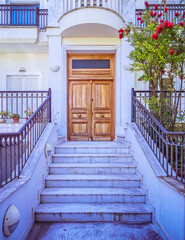 contemporary house entrance with white marble stairs and wooden door, Athens Greece