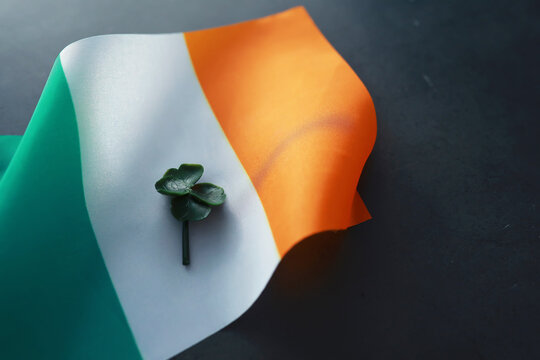 Saint patrick's day background with ireland flag. Religious Christian holiday. Four-leaf clover symbol of good luck.