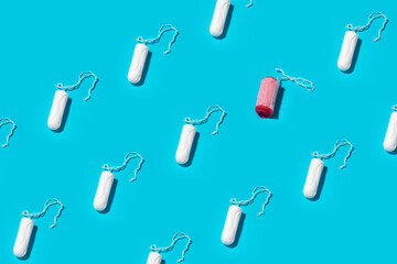 Unused and one used cotton tampons on a blue background. Seamless repeating pattern.