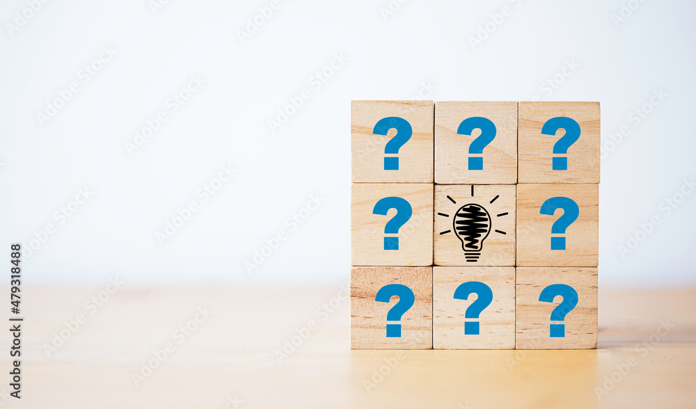 Poster drawing lightbulb print screen on wooden cube block among question mark for question and answer conc
