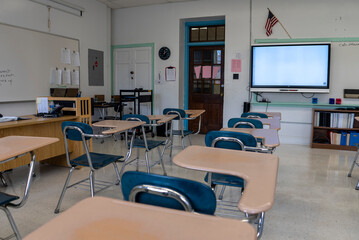 Empty schoolroom with interactive whiteboard for teaching students in high, middle, and elementary school.