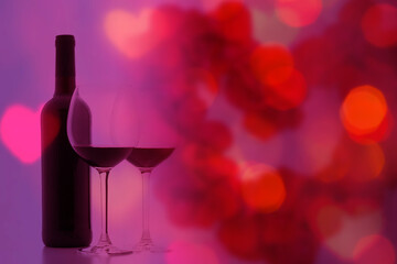 bottle of red wine with glasses on the background of romance and love, valentines day bokeh