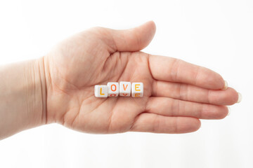love concept word from cubes in human hand