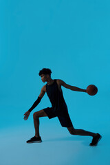 Fototapeta na wymiar Black focused male player throwing basketball ball