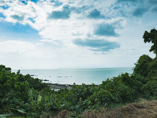 A panoramic view of the sea, trees and sky in southern Thailand.