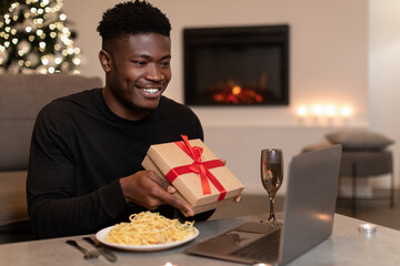 Black Man Video Calling Showing Present To Laptop At Home