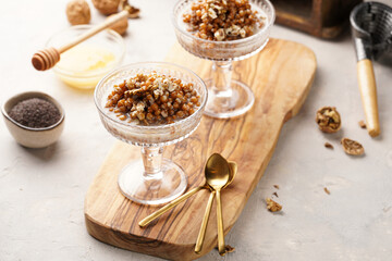 Fototapeta premium Traditional east european (ukrainian, polish, belarusian) religious christmas dish kutia made of wheat, poppy seeds, honey, walnuts and dried berries. modern style in champagne glasses