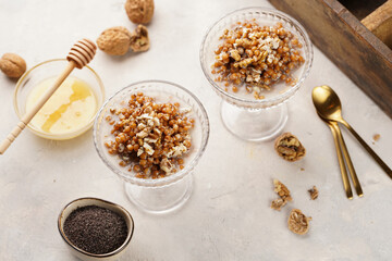 Traditional east european (ukrainian, polish, belarusian) religious christmas dish kutia made of wheat, poppy seeds, honey, walnuts and dried berries. modern style in champagne glasses