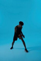 Obraz na płótnie Canvas Black focused player dribble with basketball ball