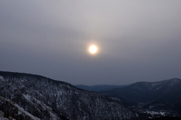 Sunset in the mountains. Mountain landscape in winter. Snow-covered rocks. Bad weather in the mountains.  - 479325005