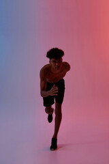 Serious sportsman running and looking at camera