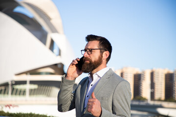 handsome businessman with phone in the city