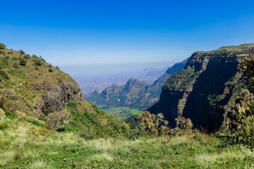 Fototapeta na wymiar Panoramic View to the Simien Mountains Green Valley under Blue Sky near Gondar, Northern Ethiopia