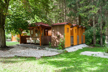 Wooden houses in the woods serving as a bathroom and toilet in a camp near the town of Kransjak Gora in Slovenia.