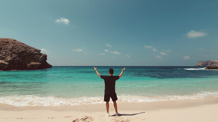 person jumping on the beach