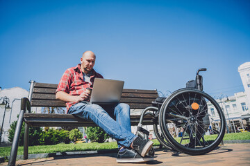 Freelancer with a physical disability who uses wheelchair working at the park