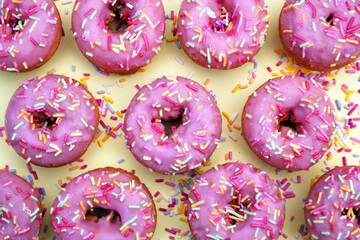 donut donuts pink sprinkles on doughnuts pink bright sugar strands yellow pastel flat lay repeat pattern background
