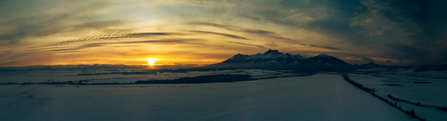 Fototapeta na wymiar Winter mountain landscape at sunset. Sun and peaks in High Tatra Mountains