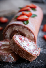 Delicious strawberry roll cake with white cream, homemade baked dessert