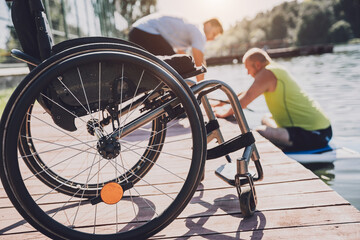 Person with a physical disability who uses wheelchair will be ride on sup board