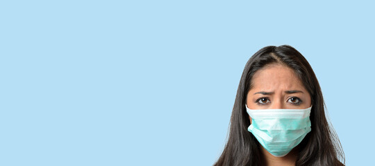 Woman wearing a green medical protective mask against Covid