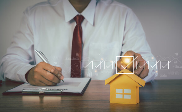 Businessman working with property values. Checking mark up on the check boxes. Successful completion of business tasks. Business management goal strategy. Housing Investment buying and selling.