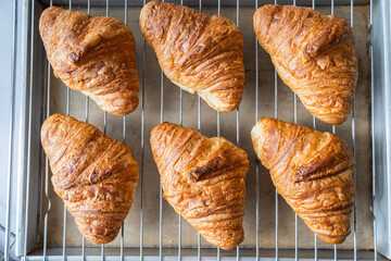 Croissants on baking rack