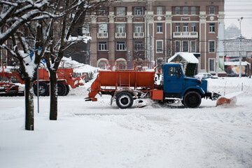 Obraz premium Snowplow removing snow from city road