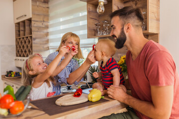 Fototapeta Parents and children having fun in the kitchen obraz