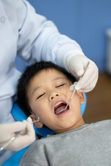 Asian kid check up with dentist at the dental clinic. Concept of dental check up and healthcare