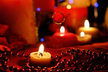 
Fortune-telling on fire and a ring, Russian divination for love at Christmas. Burning red candles,...