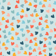 Seamless pattern with hand drawn multicolored heart shapes on blue background, for wrapping paper and other design projects. Valentines Day concept, love, romance concept