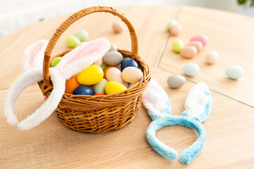Easter cake and colorful eggs and flowers on the foreground