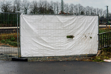 construction roadblock with scaffolding and protective netting is used for safety and to avoid dust...