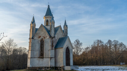 Neo-Gothic style chapel on sunset sky background. Religious concepts.
