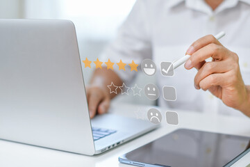 Businessman touches the virtual screen on the happy smiley face icon to give five stars rating. Very satisfied and impressed in service. Customer service and Satisfaction concept.